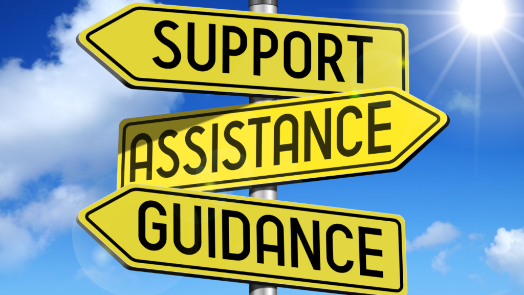 image with three yellow signs pointing in different directions. one says "support" the other says "assistance" the 3rd says "guidance"